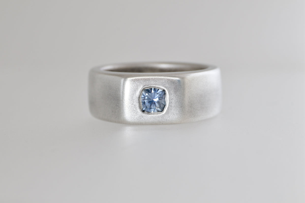 Satin sterling silver signet ring with light blue Umba sapphire cushion